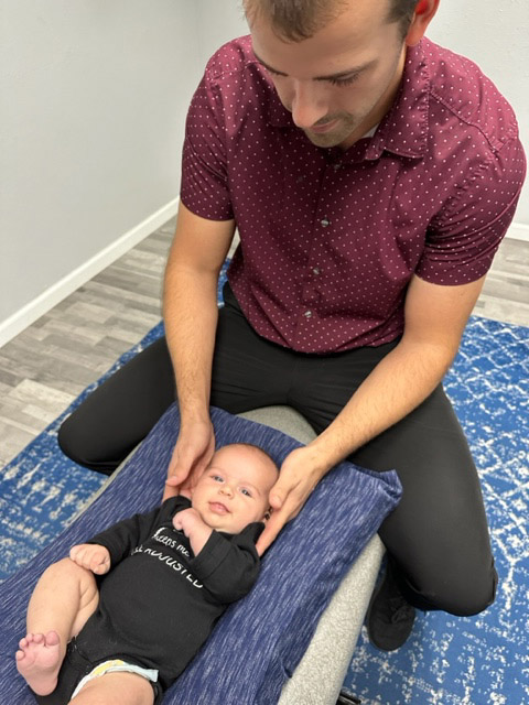 Dr Parker Adjusting Baby Child - Pediatric Chiropractic